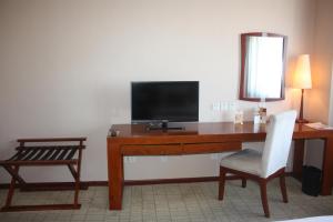 a room with a desk with a television and a chair at Super House International in Beijing