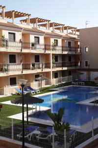 un gran edificio de apartamentos con una gran piscina en Apartamentos Turisticos Aguilas de los Collados, en Águilas