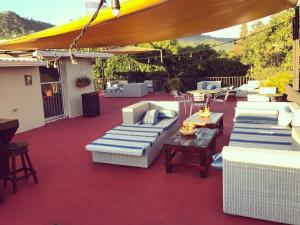 a group of chairs and umbrellas on a patio at Palmira Hostel in Tegucigalpa