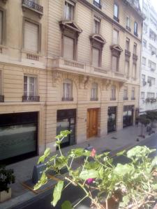 a building on a street with a plant in front of it at Marcelo T de Alvear 800 in Buenos Aires