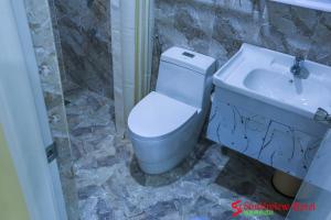 a bathroom with a toilet and a sink at Southview Hotel in Dumaguete
