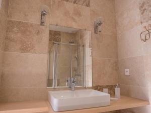 a bathroom with a sink and a shower at La Cour Verte in Gaillac