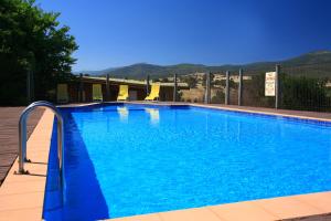 a large blue swimming pool with blue water at Off Mountain Accommodation in Merrijig