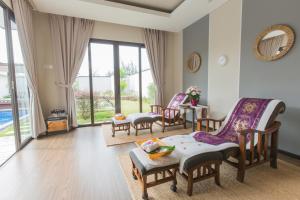 a living room with chairs and a table at Pantai Indah Lagoi Bintan in Lagoi