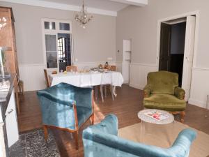 a living room with a table and two chairs at La Cour Verte in Gaillac