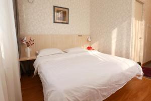Postel nebo postele na pokoji v ubytování Beijing Sicily Hotel