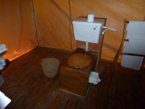 a bathroom with a toilet in a tent at Roika Tarangire Tented Lodge in Kwa Kuchinia