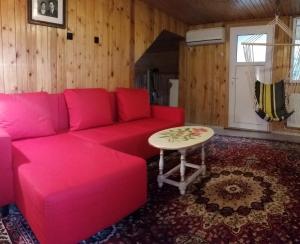 sala de estar con sofá rosa y mesa en Lelia Residence Apartments, en Brasov