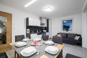 a dining room and living room with a table and chairs at Fischis Alpen Appartements in Flachau