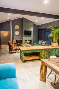 a living room with a table and a couch at 368 on Vaal | Riverside Retreat in Parys