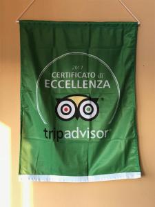 a green flag hanging on a wall with the olympics at Corte Dossello in Migliaro