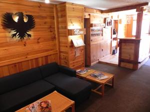 ein Wohnzimmer mit einem Sofa und einem Tisch in der Unterkunft Hôtel Résidence Les Colchiques in Le Monêtier-les-Bains