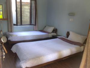 Postelja oz. postelje v sobi nastanitve Yeti Guest House