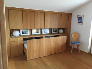 a wooden cabinet with a blue chair in a room at Marie-Anne in Garmisch-Partenkirchen