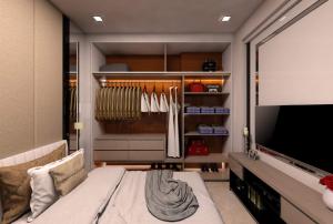 a room with a tv and a closet with hangers at Educity Apartment Princeton - Jusuf in Surabaya +25 photos