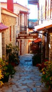 a stone alley with a sign in a building at Pension Maria in Arachova