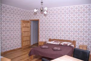 a bedroom with a bed and a pink wall at Ventspils Centra Apartamenti in Ventspils
