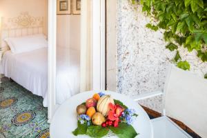 a plate of fruit on a table in a room at Hotel Continental Ischia in Ischia