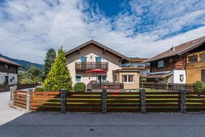 a house with a fence in front of it at Almliesl MAIS-428 in Maishofen