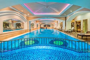 a large swimming pool in a building with a ceiling at Elite World Van in Van