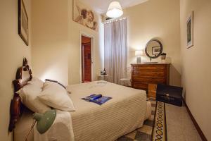 sypialnia z łóżkiem, komodą i lustrem w obiekcie RomaAmor w Rzymie