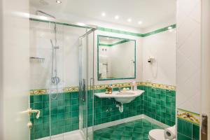 a bathroom with a glass shower and a sink at Hotel Continental Ischia in Ischia