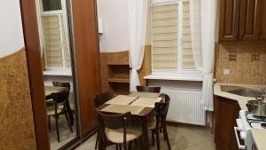 a small kitchen with a table and chairs and a sink at Soprano apartment in Lviv