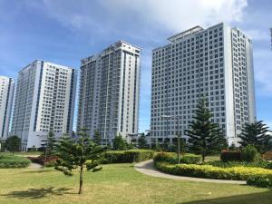 three tall buildings with trees in a park at Wind Residences Condotel in Tagaytay