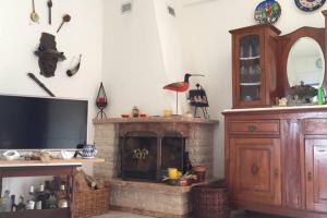 a living room with a tv and a fireplace at Isabelle's apartment in Kallithea Halkidikis
