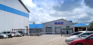 a dmg car dealership with cars parked in a parking lot at Apartments DAF-Center in Uralsk
