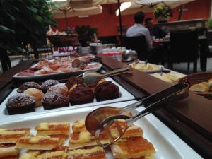 a buffet of pastries and donuts on a table at Trattoria Locanda Ai Tre Amici in Mortegliano