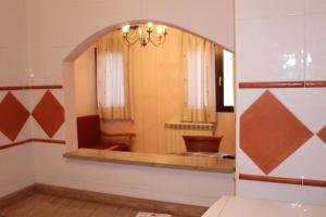 a mirror in a bathroom with a toilet and a sink at ATRA in Santa Cruz de Moya