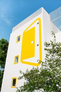 a yellow door on the side of a building at Bloomrooms @ Link Road in New Delhi