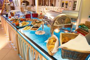 a buffet line with many different types of food at Dworek Dębówko in Bartoszyce