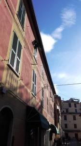 a red building with windows on a street at Studio FEDE in Levanto