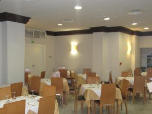 a dining room with tables and chairs in a room at Don Juan in Granada