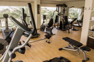 a gym with several treadmills and exercise bikes at Jaz Sharks Bay in Sharm El Sheikh