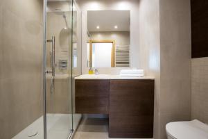 a bathroom with a shower and a sink and a toilet at Baltic Apartments Seaside Towers in Gdańsk