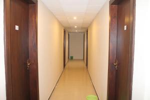 a corridor in a hospital with two doors and a long hallway at Green Palace Colombo in Colombo