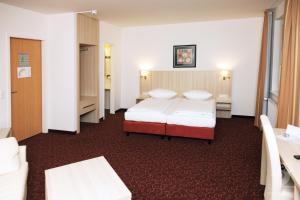 Postel nebo postele na pokoji v ubytování Hotel Quickborn & Gästehaus Hesse + 22 fotografií