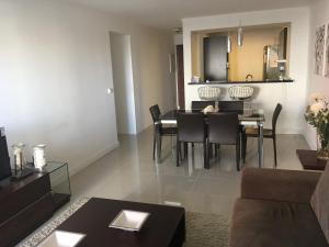 a living room with a couch and a dining room at Apartamento Forest 2 in Punta del Este