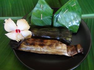 a plate of food with asparagus and a flower at Tuaprodhome in Khao Lak