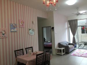 a dining room with a table and a chair and a living room at Cameron DreamWorld Apartment @ Golden Hill in Cameron Highlands