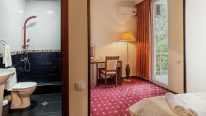 Voodi või voodid majutusasutuse Orange Hotel toas