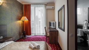 Voodi või voodid majutusasutuse Orange Hotel toas
