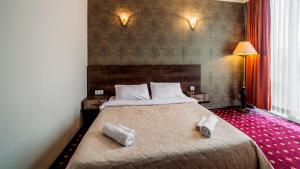 Voodi või voodid majutusasutuse Orange Hotel toas