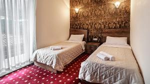 Voodi või voodid majutusasutuse Orange Hotel toas