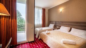 Voodi või voodid majutusasutuse Orange Hotel toas