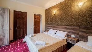 Voodi või voodid majutusasutuse Orange Hotel toas