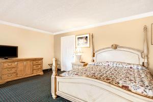 a bedroom with a bed and a flat screen tv at Knights Inn Mount Laurel in Mount Laurel